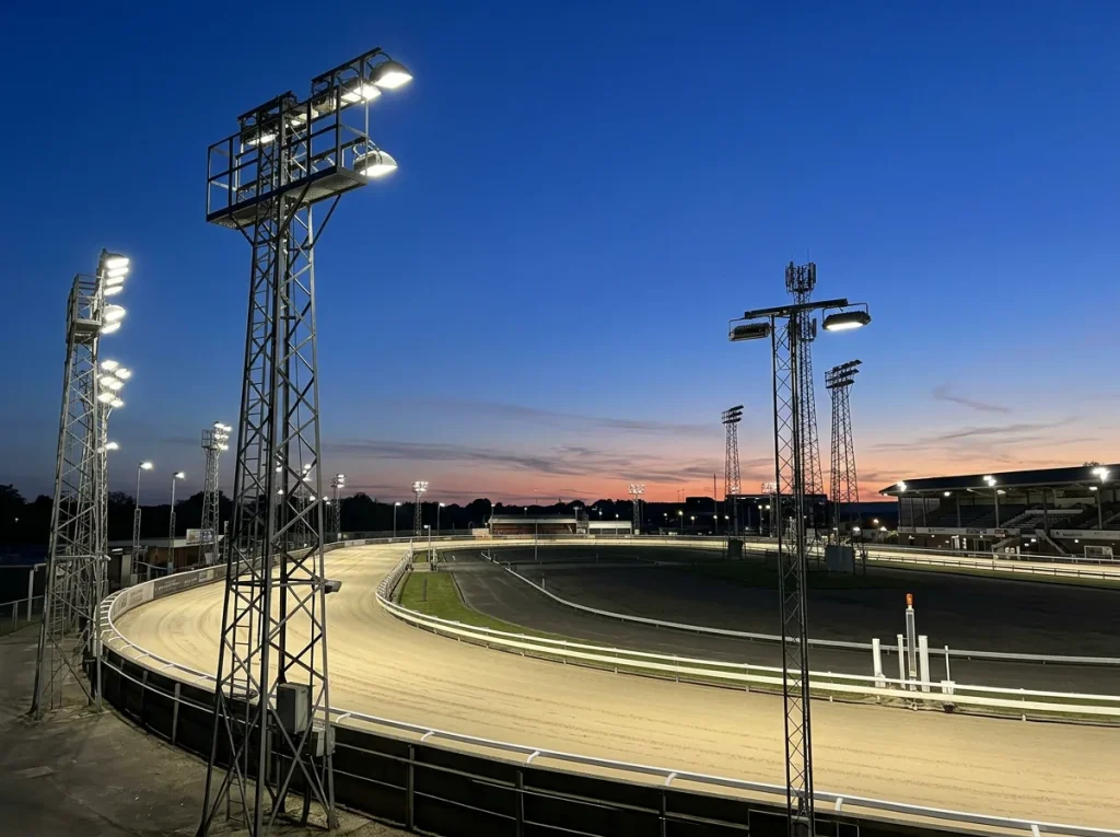 Yarmouth Stadium floodlights illuminating the track on a race evening